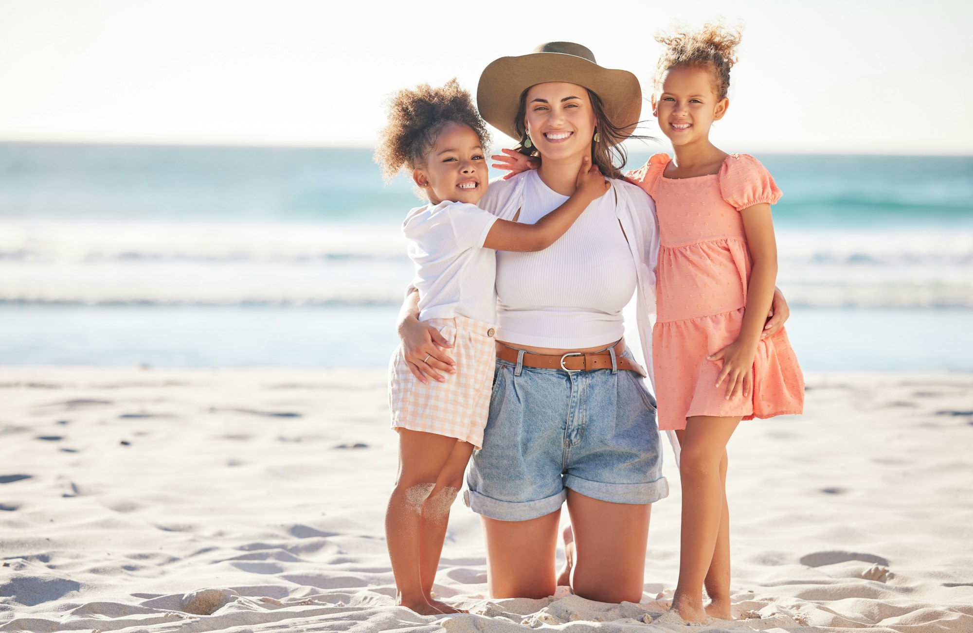 Beach, portrait and mother with children on sand for Puerto Rico holiday together with family. Happ